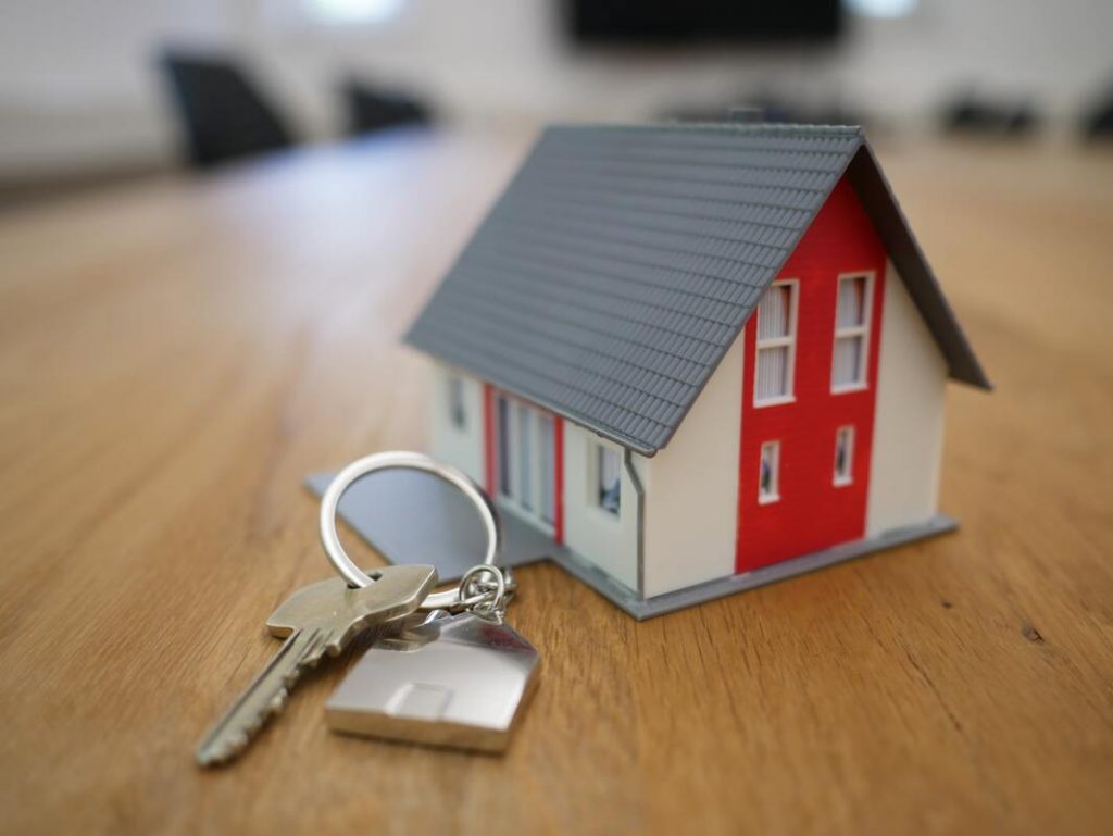 miniature house with a key besite it conceptualizing rental property